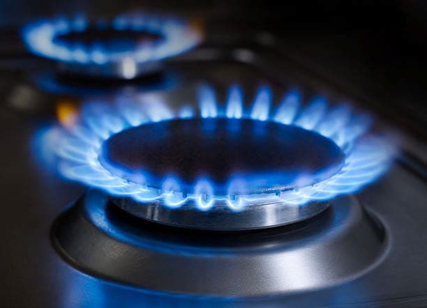 A blue gas flame burning on a stove